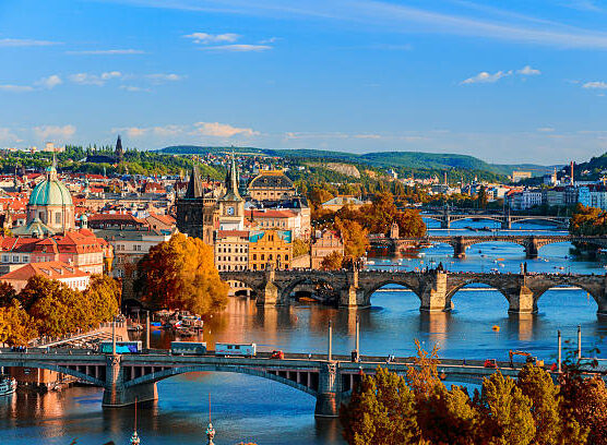 View of the Vltava River and Charle bridge with red foliage, Prague, Czech Republic